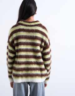 Model wearing Knitted v neck fluffy polo in green and brown