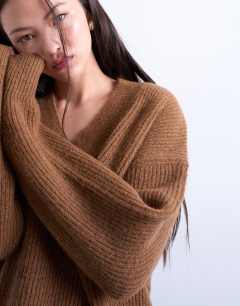 Model wearing Knitted v neck jumper in brown