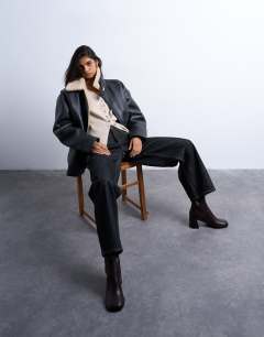 Model wearing Knitted V neck longline clean cinch waist cardigan in oat