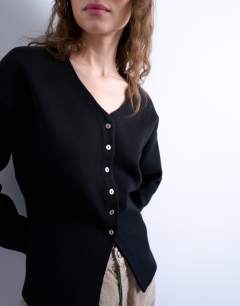 Model wearing Knitted V neck longline compact fitted waist cardigan in black