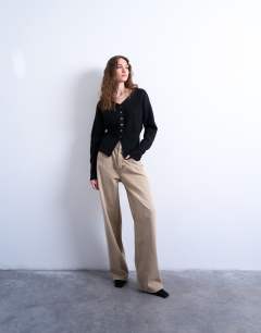Model wearing Knitted V neck longline compact fitted waist cardigan in black