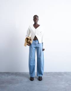 Model wearing Knitted V neck longline compact fitted waist cardigan in ivory