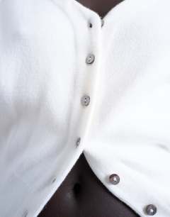 Model wearing Knitted V neck longline compact fitted waist cardigan in ivory