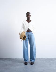 Model wearing Knitted V neck longline compact fitted waist cardigan in ivory