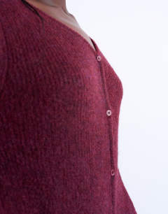 Model wearing Knitted v-neck ribbed cardigan in burgundy