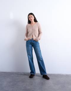 Model wearing Knitted v-neck ribbed cardigan in stone