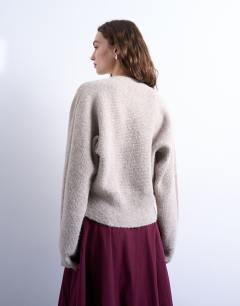 Model wearing Knitted v neck slouchy cardigan in oat