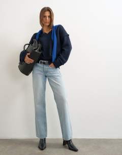 Model wearing Knitted v neck slouchy roll seam detail jumper with wool in midnight