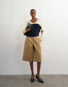 Model wearing Knitted v neck stripe batwing jumper in blue multi