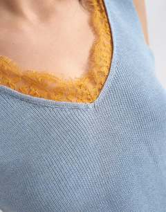 Model wearing Knitted vest in blue with orange contrast lace 