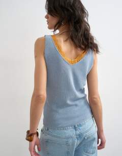Model wearing Knitted vest in blue with orange contrast lace 