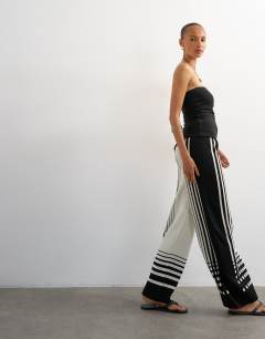 Model wearing Knitted wide leg trouser in black and ecru