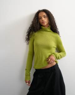 Model wearing Knitted wool blend double layer sheer turtleneck top in green