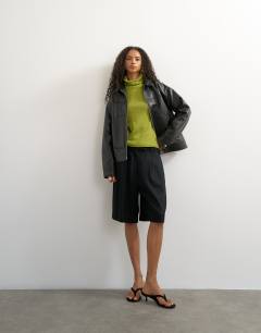 Model wearing Knitted wool blend double layer sheer turtleneck top in green