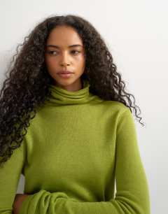 Model wearing Knitted wool blend double layer sheer turtleneck top in green