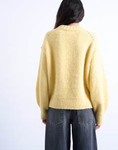 Model wearing Knitted wool blend fluffy exposed seam easy jumper in butter yellow