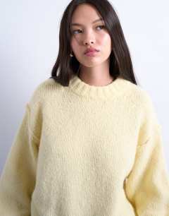 Model wearing Knitted wool blend fluffy exposed seam easy jumper in buttermilk