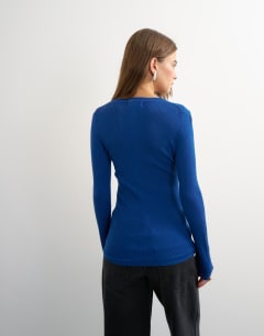 Model wearing Knitted wool blend henley long sleeve top in cobalt
