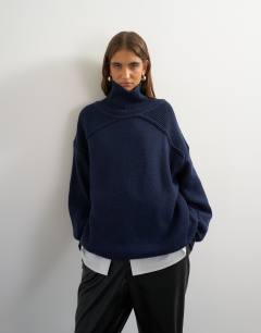 Model wearing Knitted wool blend high neck jumper in navy