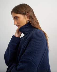 Model wearing Knitted wool blend high neck jumper in navy