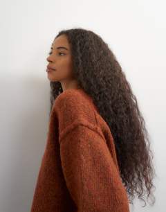 Model wearing Knitted wool blend roll edge chunky jumper in cinnamon
