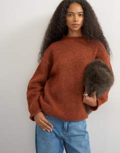 Model wearing Knitted wool blend roll edge chunky jumper in cinnamon
