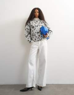 Model wearing Knitted wool blend roll edge chunky jumper in dalmatian
