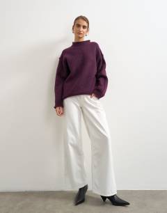 Model wearing Knitted wool blend roll edge chunky jumper in mulberry