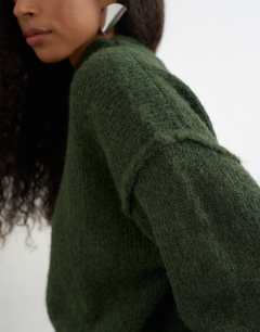 Model wearing Knitted wool blend roll edge chunky jumper in olive