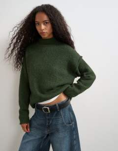 Model wearing Knitted wool blend roll edge chunky jumper in olive