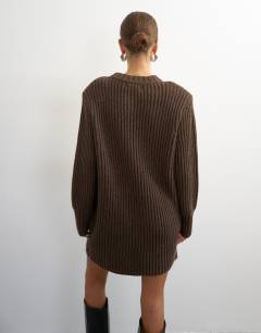 Model wearing Knitted wool blend slouchy ribbed mini dress with shoulder padding in chocolate brown