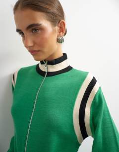 Model wearing Knitted wool blend zip through funnel neck contrast panel co-ord jacket in green
