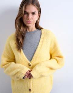 Model wearing Knitted wool brushed fluffy v neck cardigan in yellow