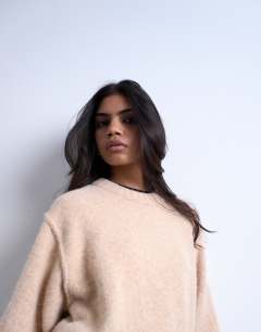 Model wearing Knitted wool crew neck mini dress in oat