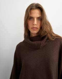 Model wearing Knitted wool short cape jumper in chocolate