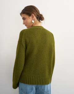 Model wearing Knitted wrap boxy cardigan with wool in moss