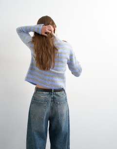 Model wearing Knitted zip up cardigan in grey and blue stripe