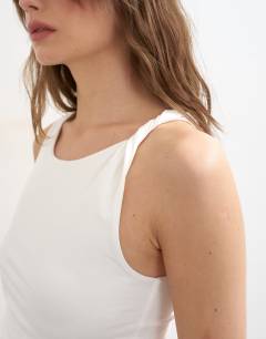 Model wearing Knot detail ruched side tank in ivory