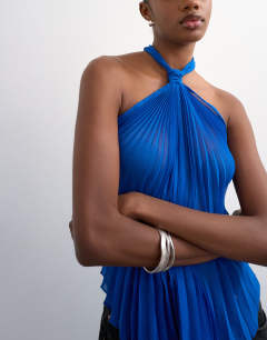 Model wearing Knot halter top with pleated fabric in cobalt blue