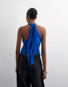 Model wearing Knot halter top with pleated fabric in cobalt blue