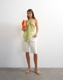 Model wearing Knot halter top with pleated fabric in green spot