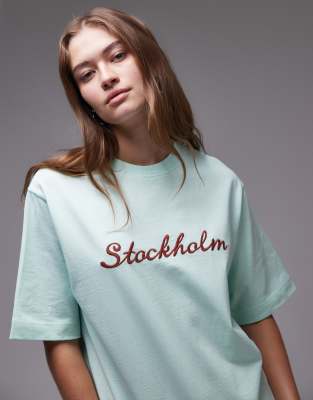 Topshop - Kurzärmliges T-Shirt aus hochwertigem Stoff in Bau mit „Stockholm"-Stickerei-Blau