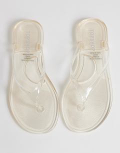 Model wearing Kylie jelly toe thong sandal in clear