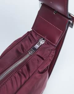 Model wearing Kylie nylon cross body with contrast strap in burgundy