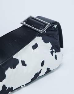 Model wearing Kylie nylon cross body with contrast strap in cow print