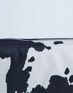 Model wearing Kylie nylon cross body with contrast strap in cow print