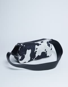 Model wearing Kylie nylon cross body with contrast strap in cow print