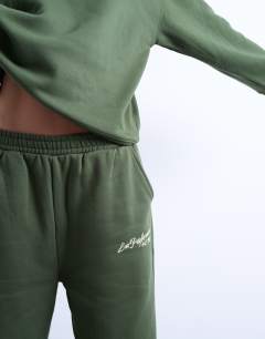 Model wearing La paloma embroidered straight jogger co-ord in green
