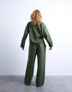 Model wearing La paloma embroidered sweatshirt co-ord in green