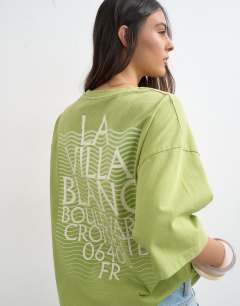 Model wearing Topshop 'La Villa Blanca' graphic oversized tee in green